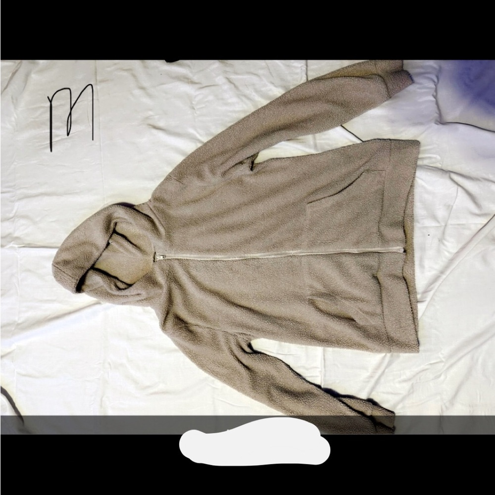 A medium tan fuzzy zip up jacket